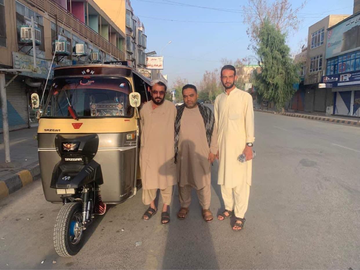 Local guides beside a rickshaw on a Kabul street