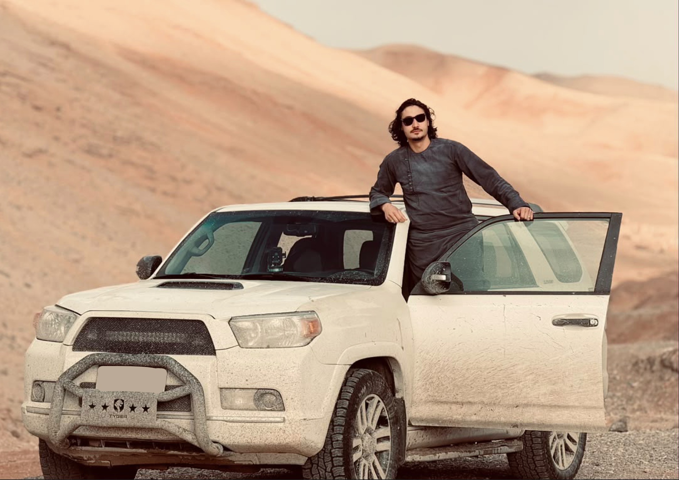 AfghanTours guide beside a four wheel drive vehicle